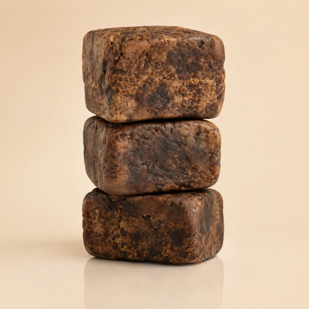 Raw African Black Soap by Timeless Organics Skin Care, showing a natural dark soap bar on a wooden surface.