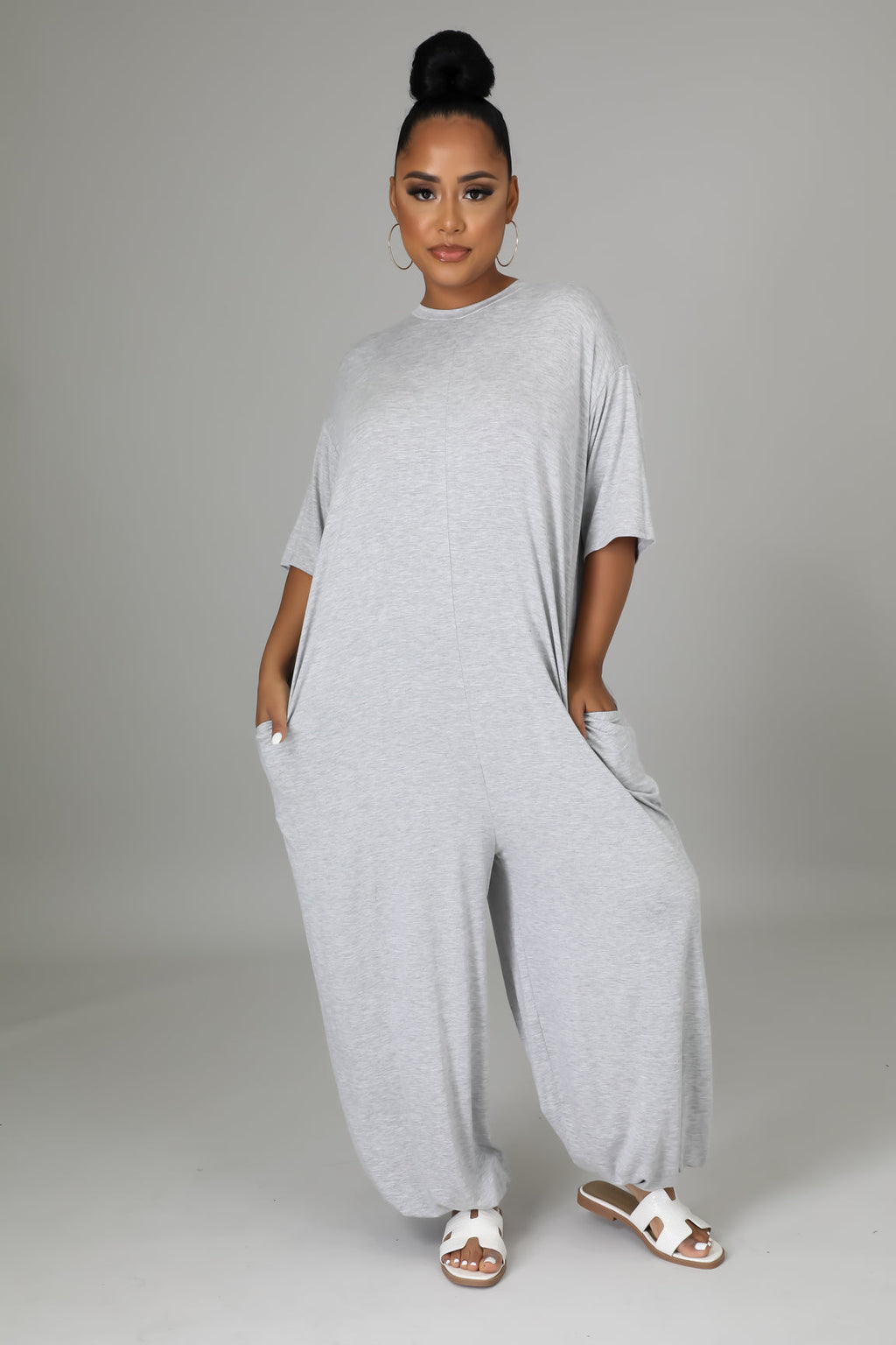 Fasheabe Justine Stretch Jumpsuit playsuit, fitted design with long sleeves and a cinched waist, displayed on a mannequin.