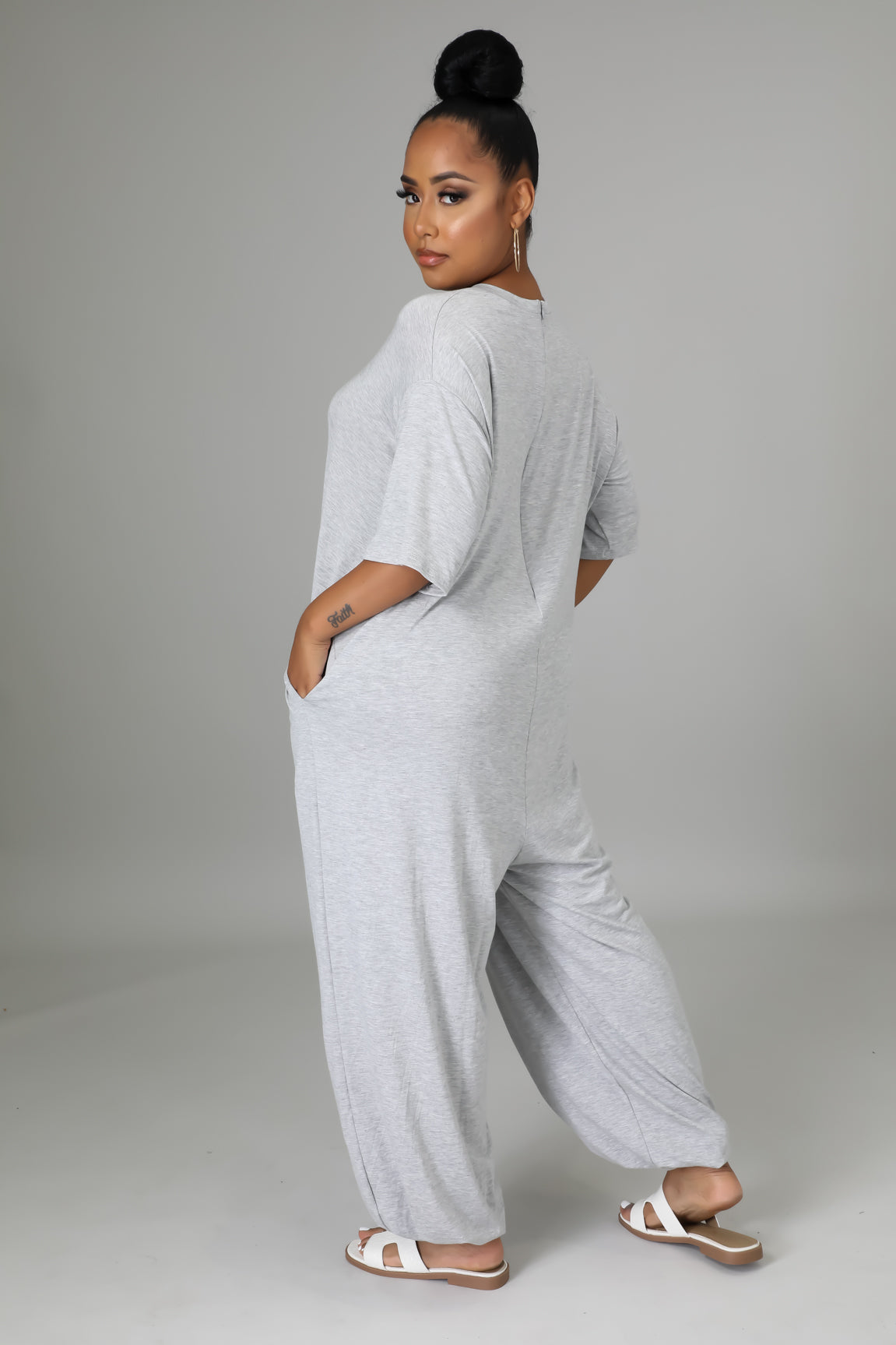 Fasheabe Justine Stretch Jumpsuit playsuit in lightweight fabric, featuring a fitted waist and stylish neckline, displayed on a hanger.