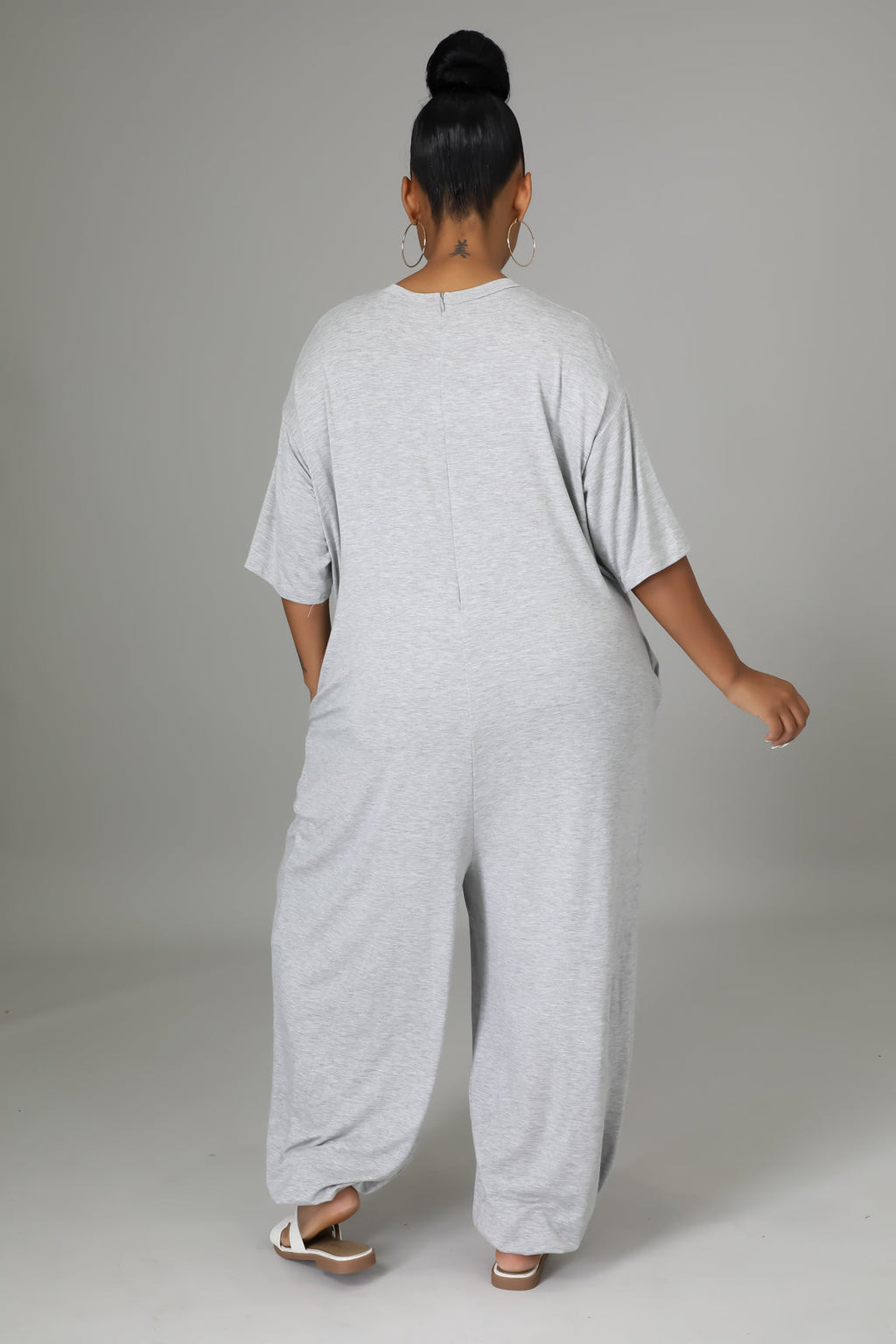 Fasheabe Justine Stretch Jumpsuit playsuit in black with fitted style, short sleeves, and V-neck design visible in the image.