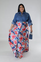 Plus size Fasheabe Jaccina dress with flowing fabric and floral pattern, displayed on a hanger against a neutral background.
