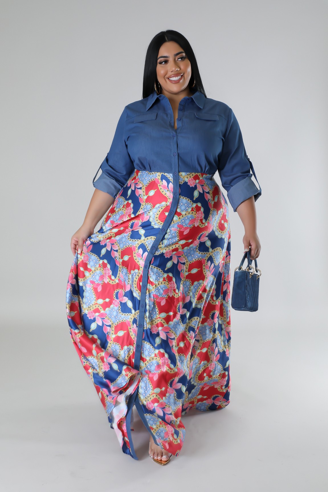 Plus size Fasheabe Jaccina dress with flowing fabric and floral pattern, displayed on a hanger against a neutral background.