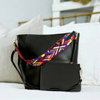 Threaded Pear Jordyn Handbag in black leather, featuring sleek design and gold-tone hardware, resting on a neutral background.