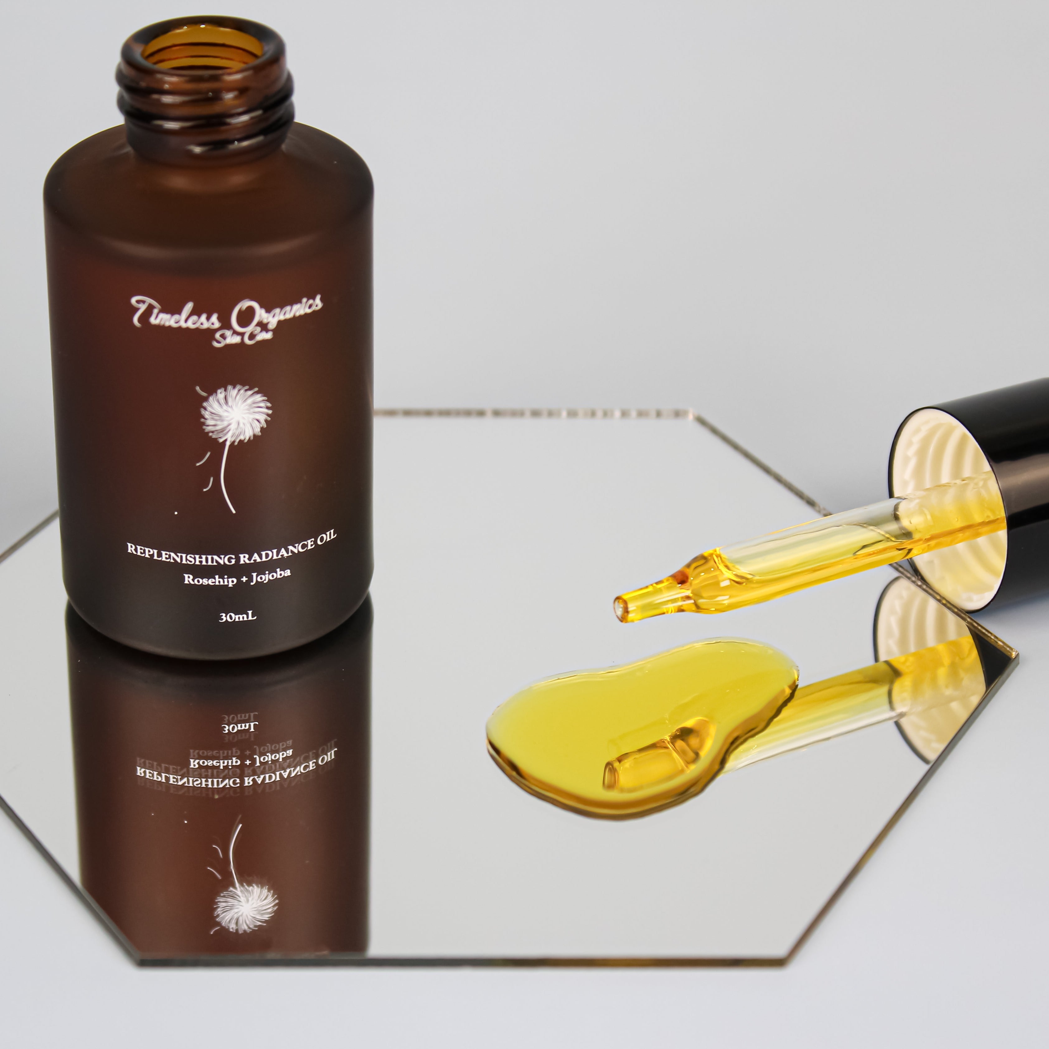Timeless Organics Skin Care Replenishing Radiance Oil serum with dropper bottle, highlighting its nourishing and revitalizing formula.