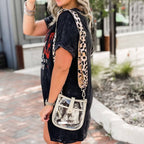 Clear compact courier bag by Threaded Pear with adjustable strap, featuring a sleek transparent design and functional storage space.