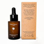 Timeless Organics Skin Care Replenishing Radiance Oil serum in a glass dropper bottle with a clear liquid inside.