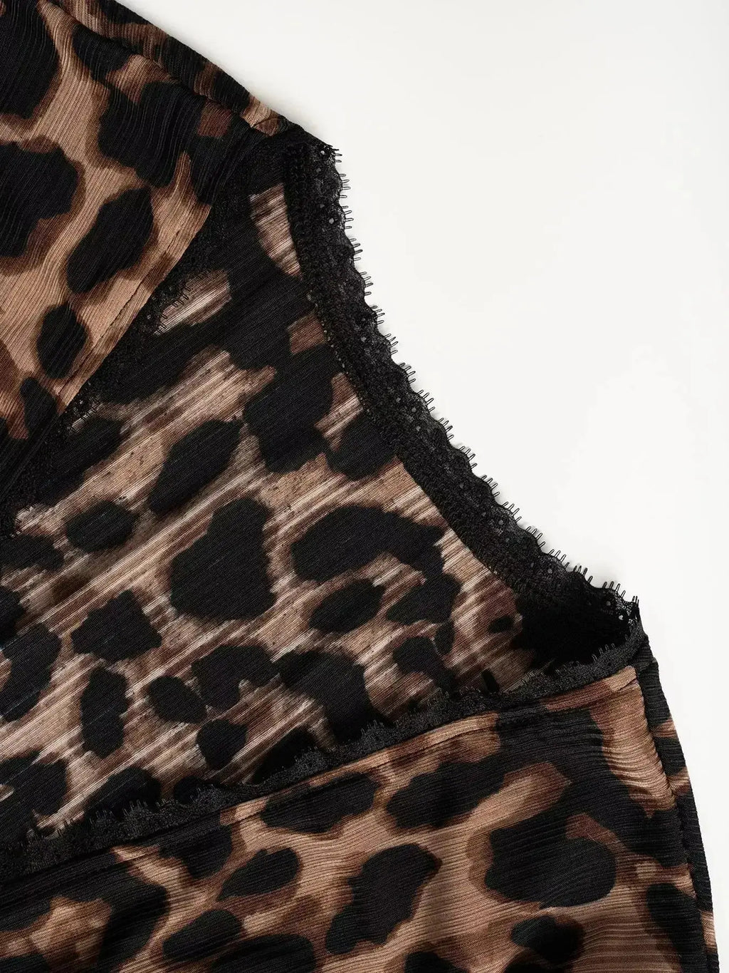 Women's leopard print button-down shirt with delicate lace accents from Plush Fashion Hub, showcasing stylish animal print and feminine details.