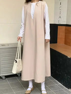 Loose V-neck sleeveless long vest dress by Plush Fashion Hub, minimalist layered midi dress on a neutral background.