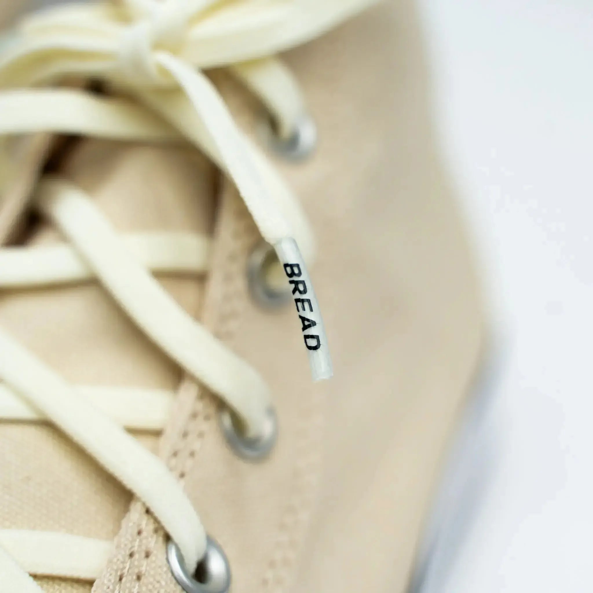 Elastic shoelaces from Plush Fashion Hub's Luxe Creme collection, featuring a soft, bread-colored design.