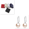 Silver pearl earrings with shell stud accents for women, featuring elegant jewelry design with a stylish and modern look.