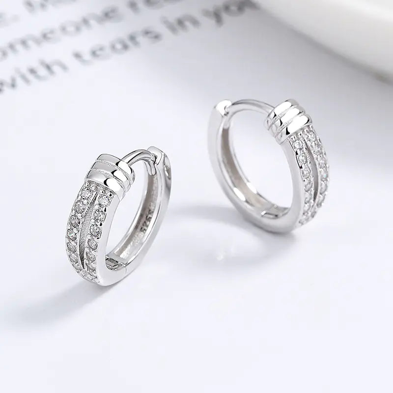 925 silver knot diamond earrings with sparkling stones, featuring elegant design and polished silver finish.
