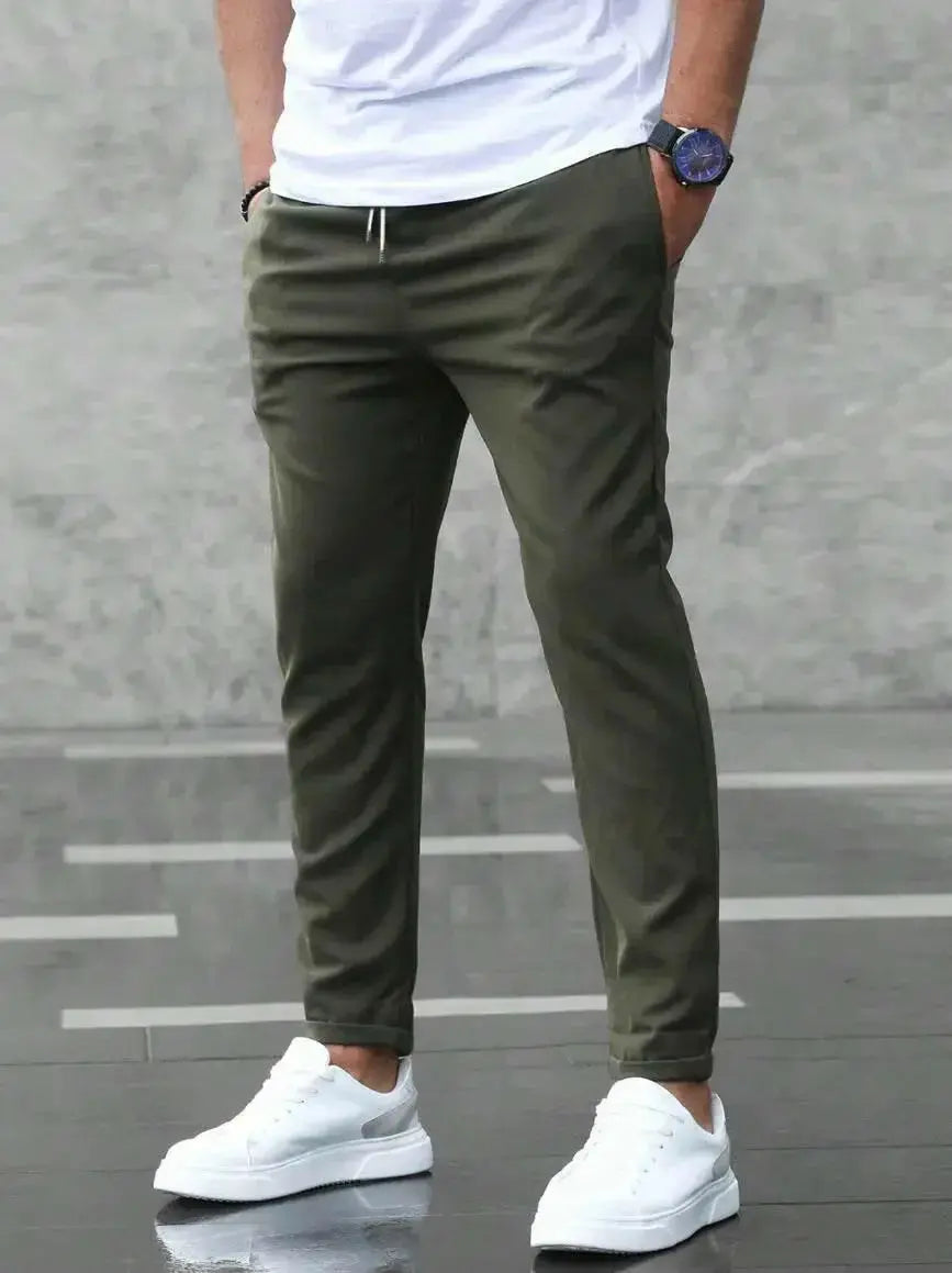 Men's slim fit casual pants with drawstring and pockets from Plush Fashion Hub, shown in a relaxed fit with stylish design.