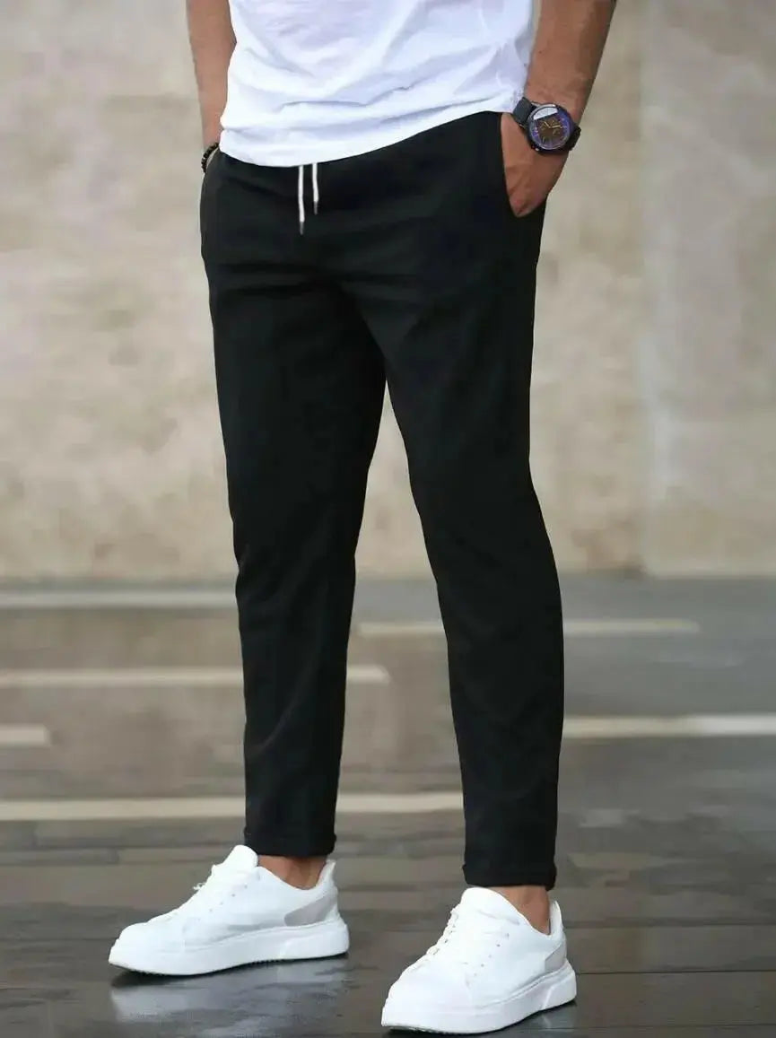 Men's slim fit casual pants with pockets and drawstring waist by Plush Fashion Hub, featuring a modern, comfortable design.
