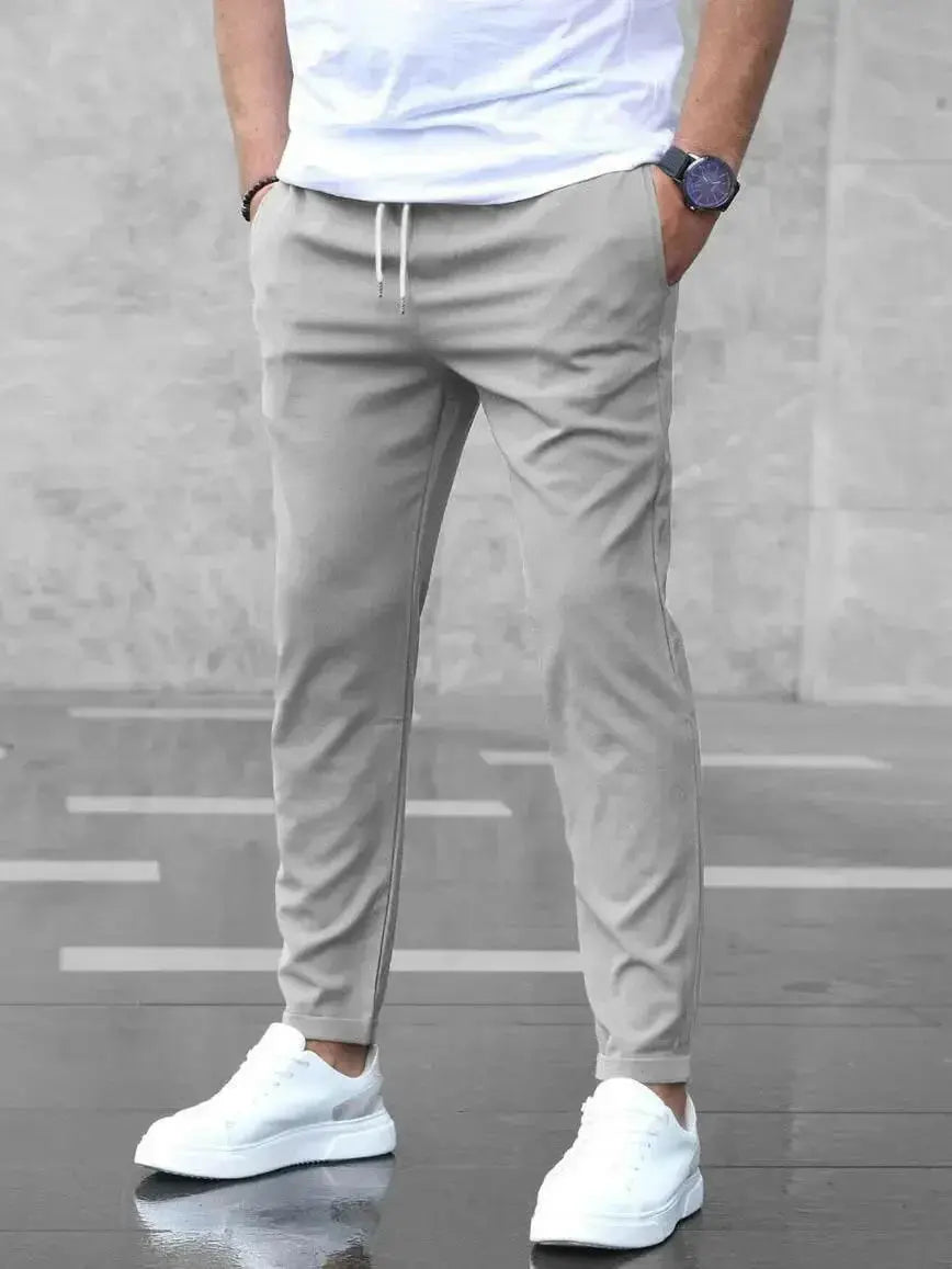 Men's slim fit casual drawstring trousers with pockets by Plush Fashion Hub, featuring a comfortable fit and stylish design.