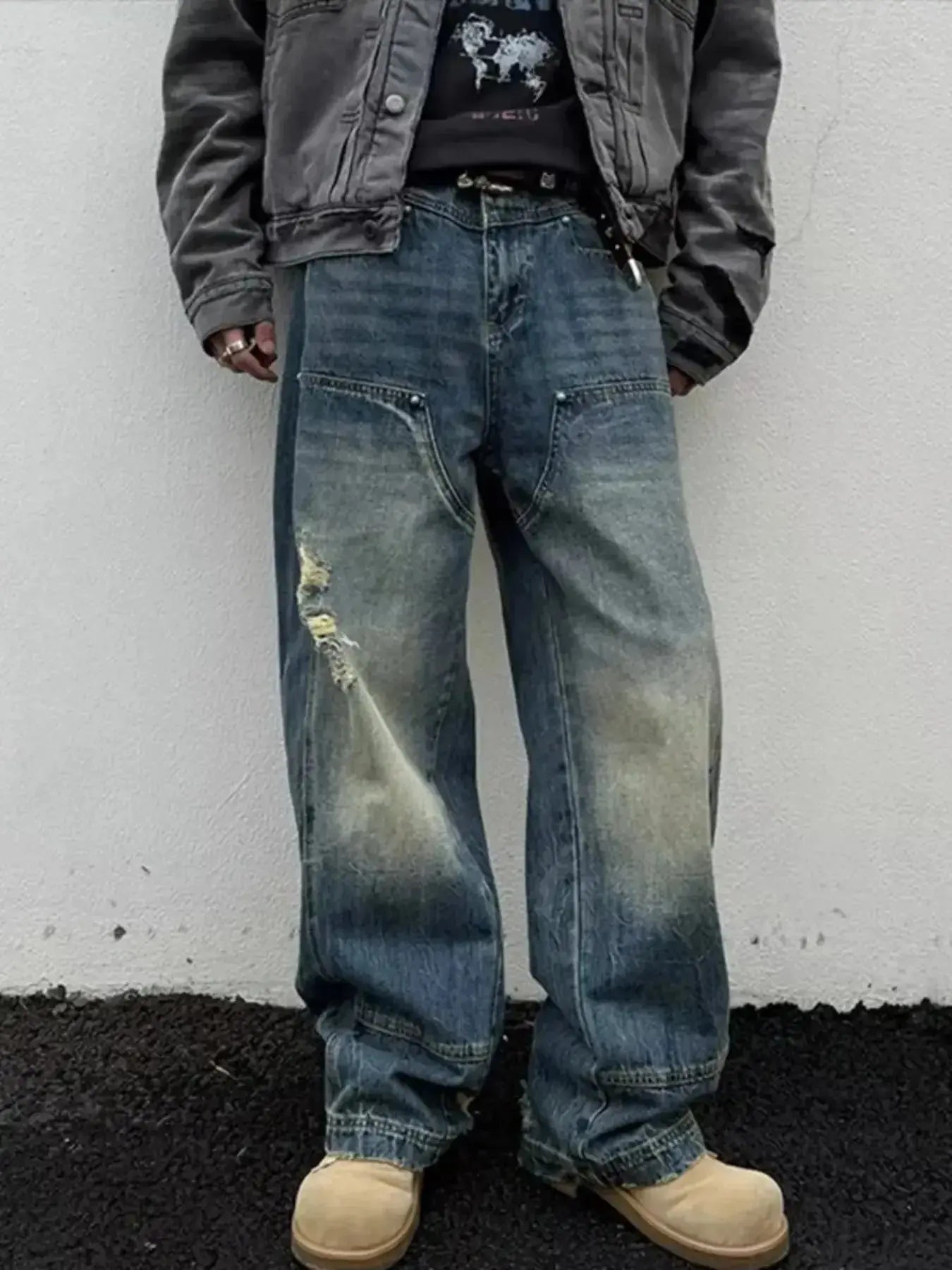 Men's distressed wide-leg jeans from Trendsi with a relaxed fit, showcasing the comfortable denim style in a casual pose.