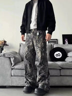 Men's relaxed fit camo print jeans with urban casual streetwear style, denim fabric, and trendy camouflage pattern.