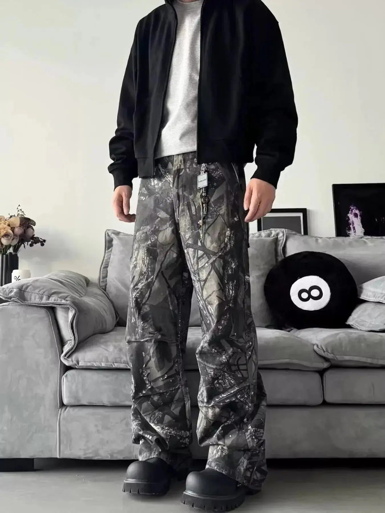 Men's relaxed fit camo print jeans with urban casual streetwear style, denim fabric, and trendy camouflage pattern.