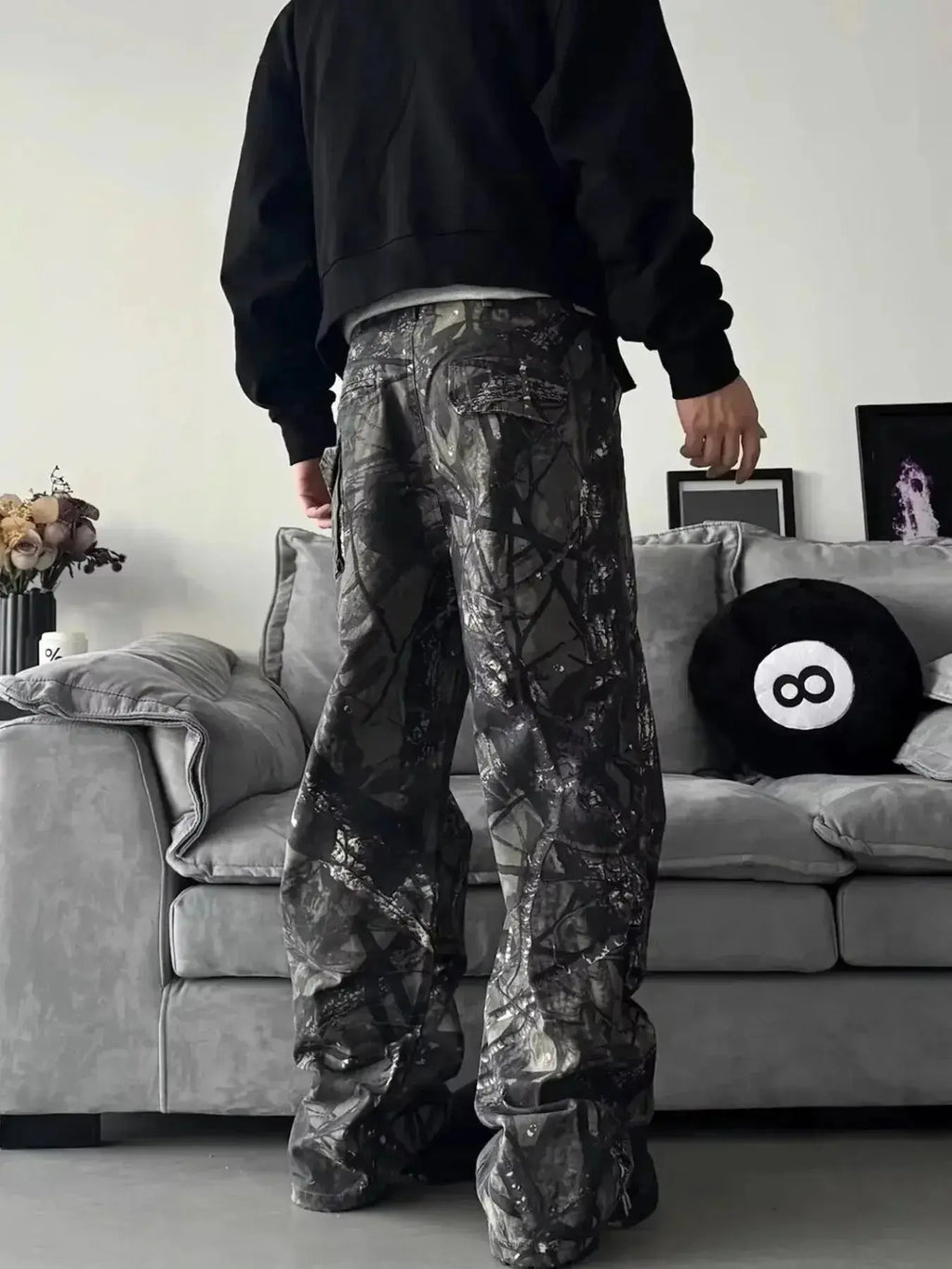 Men's relaxed fit camo print jeans with urban casual style, featuring denim fabric and streetwear-inspired design.