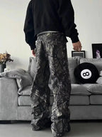 Men's relaxed fit camo print jeans with urban casual style, featuring denim fabric and streetwear-inspired design.