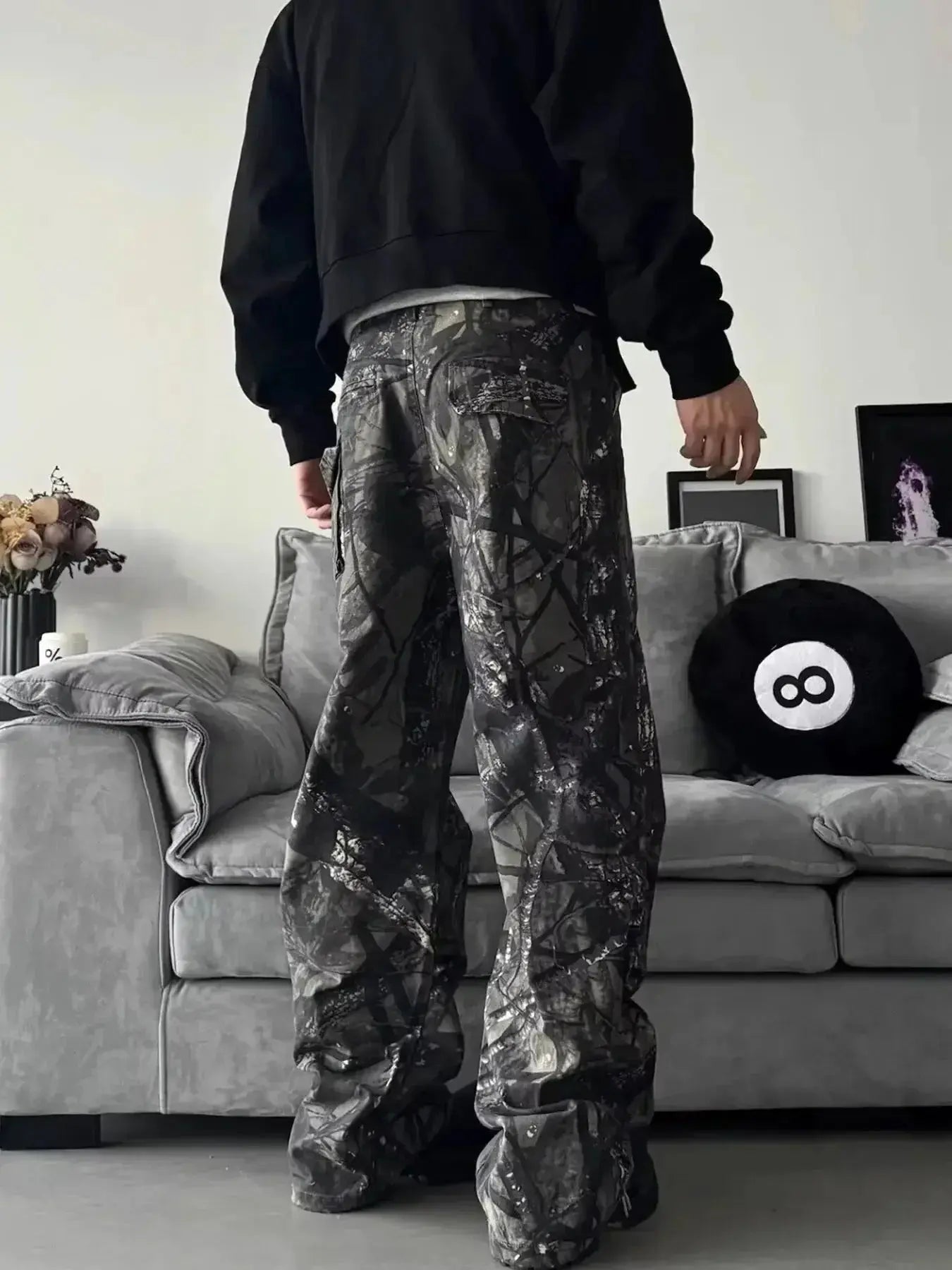 Men's relaxed fit camo print jeans with urban casual style, featuring denim fabric and streetwear-inspired design.