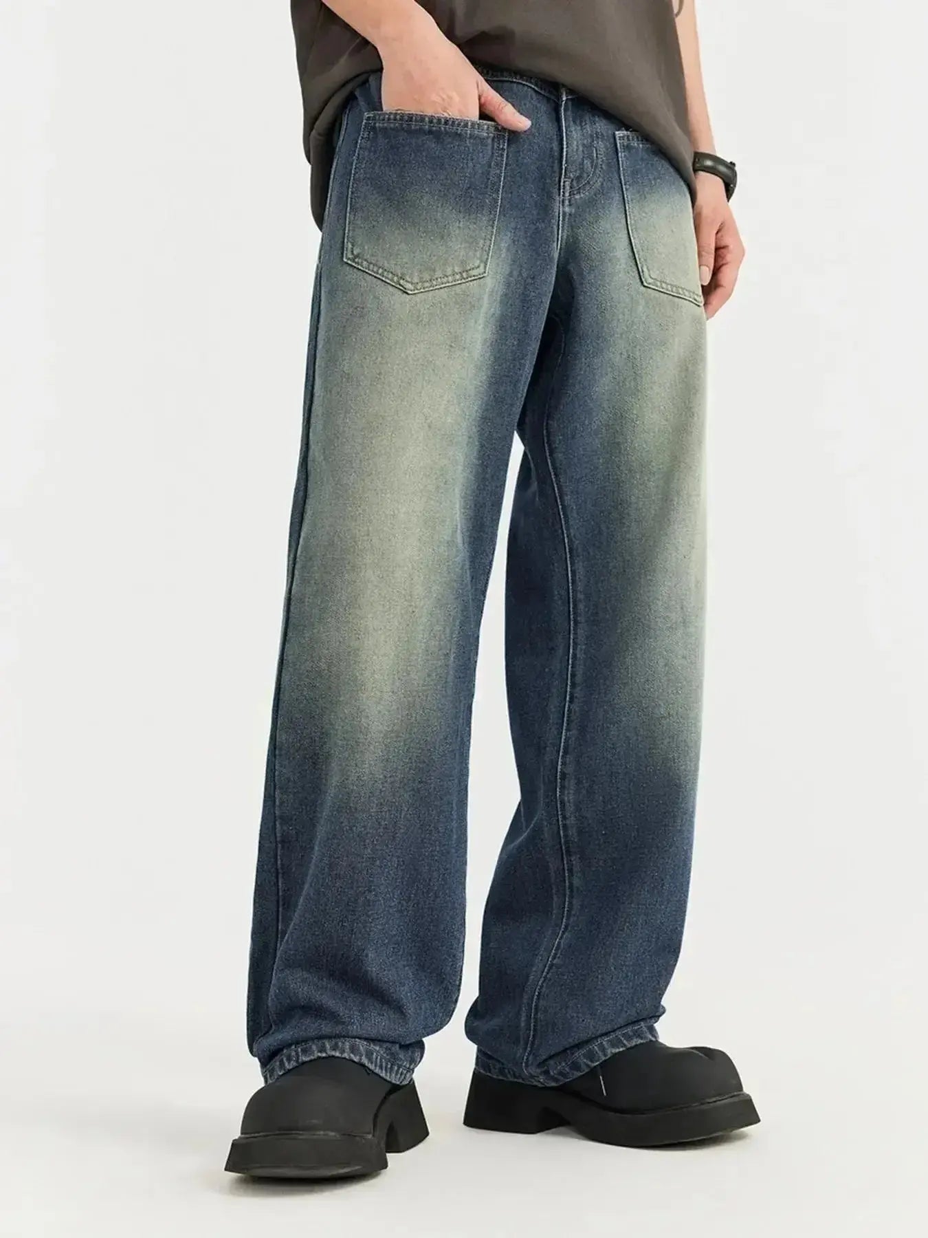 Men's vintage wash wide-leg denim jeans with relaxed fit, made from cotton, by Trendsi, shown on a model.