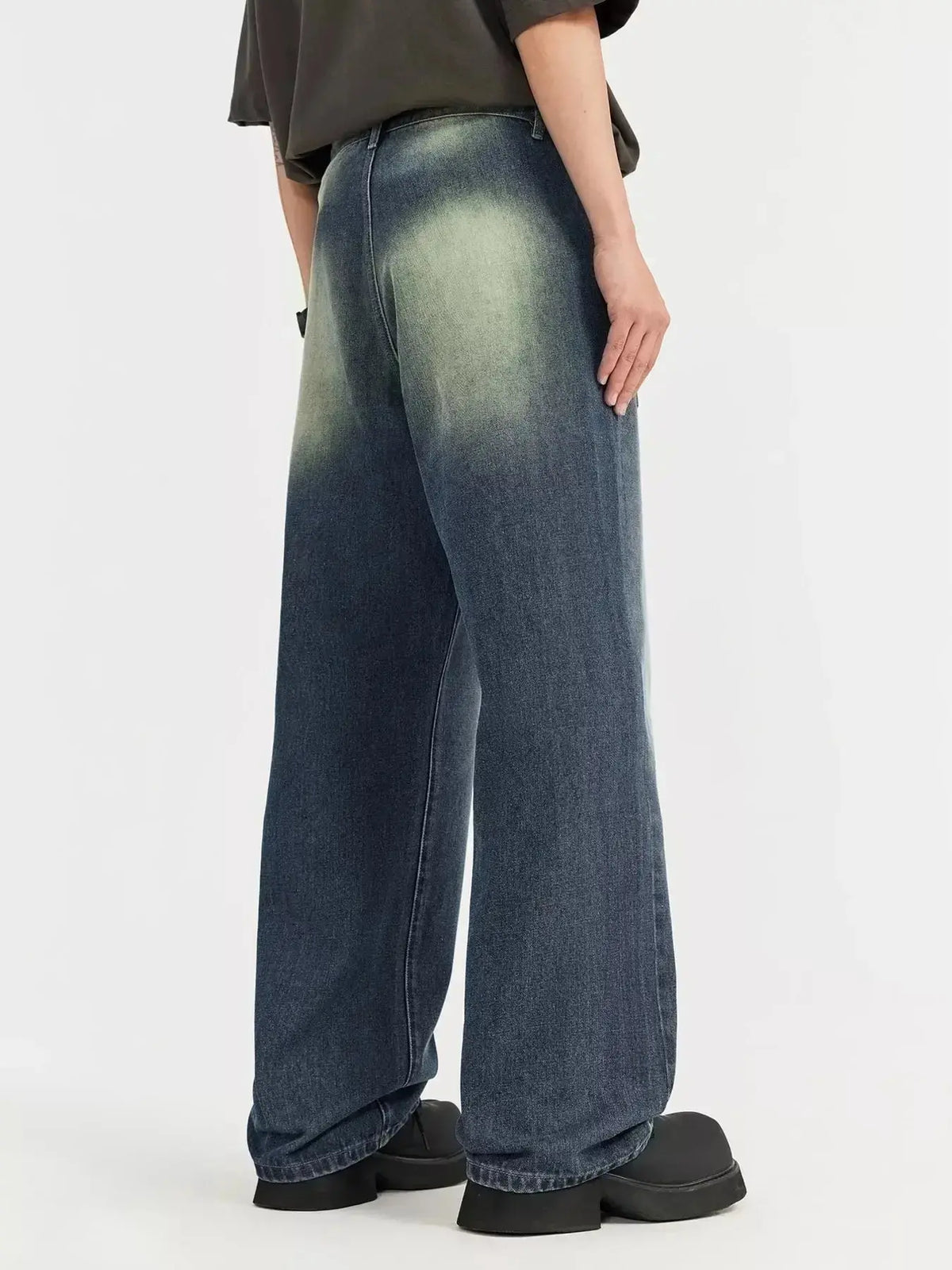 Men's vintage wash wide-leg denim jeans by Plush Fashion Hub with relaxed fit and cotton material, shown on a model.