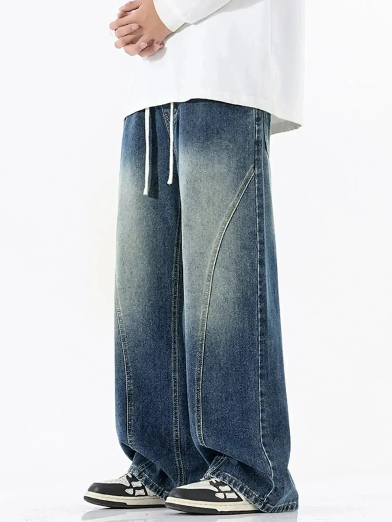 Men's vintage wash wide-leg drawstring jeans in relaxed fit cotton denim, with visible belt loops and relaxed style.