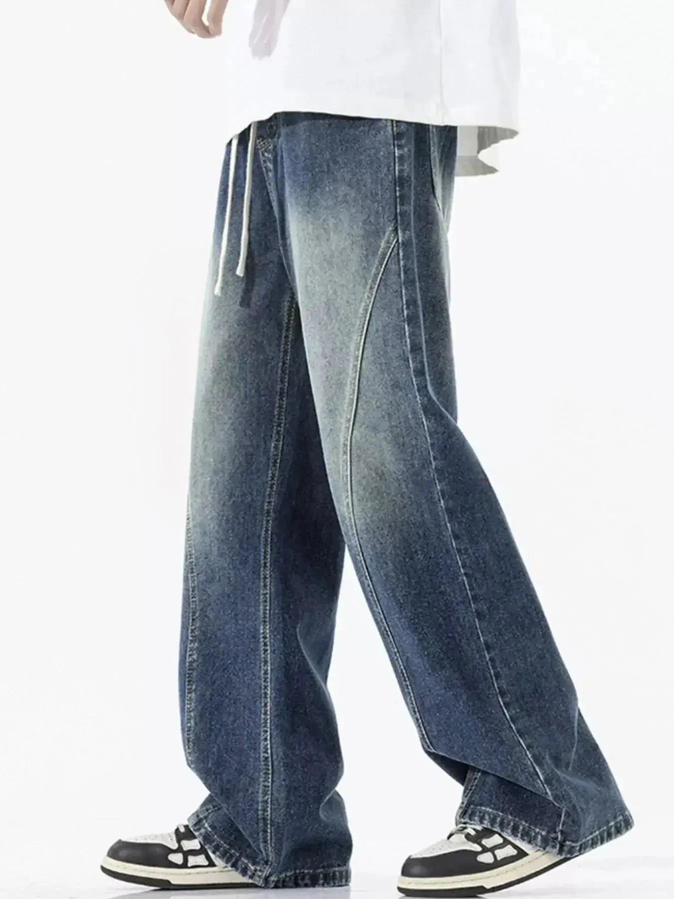 Men's vintage wash wide-leg drawstring jeans with relaxed fit made of cotton denim, featuring classic denim texture and casual style.