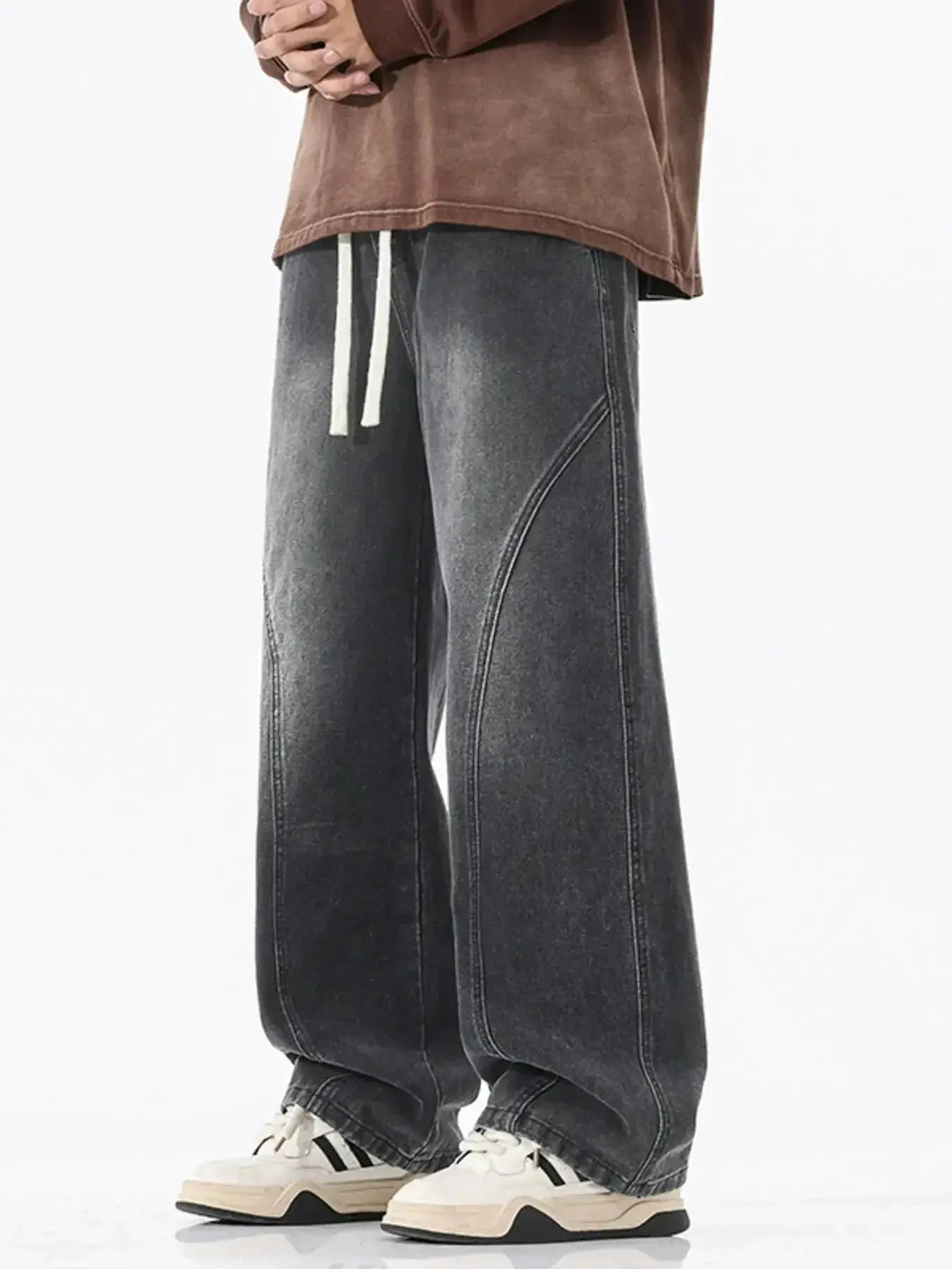 Men's vintage wash wide-leg drawstring jeans with relaxed fit in cotton denim, featuring visible stitching and a casual style.
