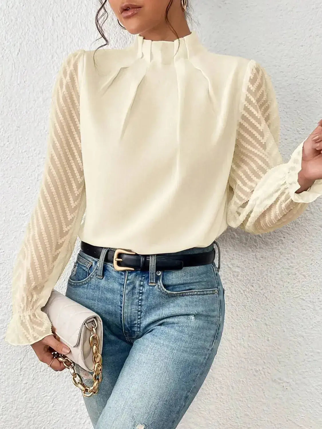 Elegant black mock neck blouse with flounce sleeves from Plush Fashion Hub, displayed on a hanger.