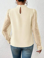 Elegant plush pink mock neck blouse with flounce sleeves, stylish shirt by Plush Fashion Hub displayed on a mannequin.