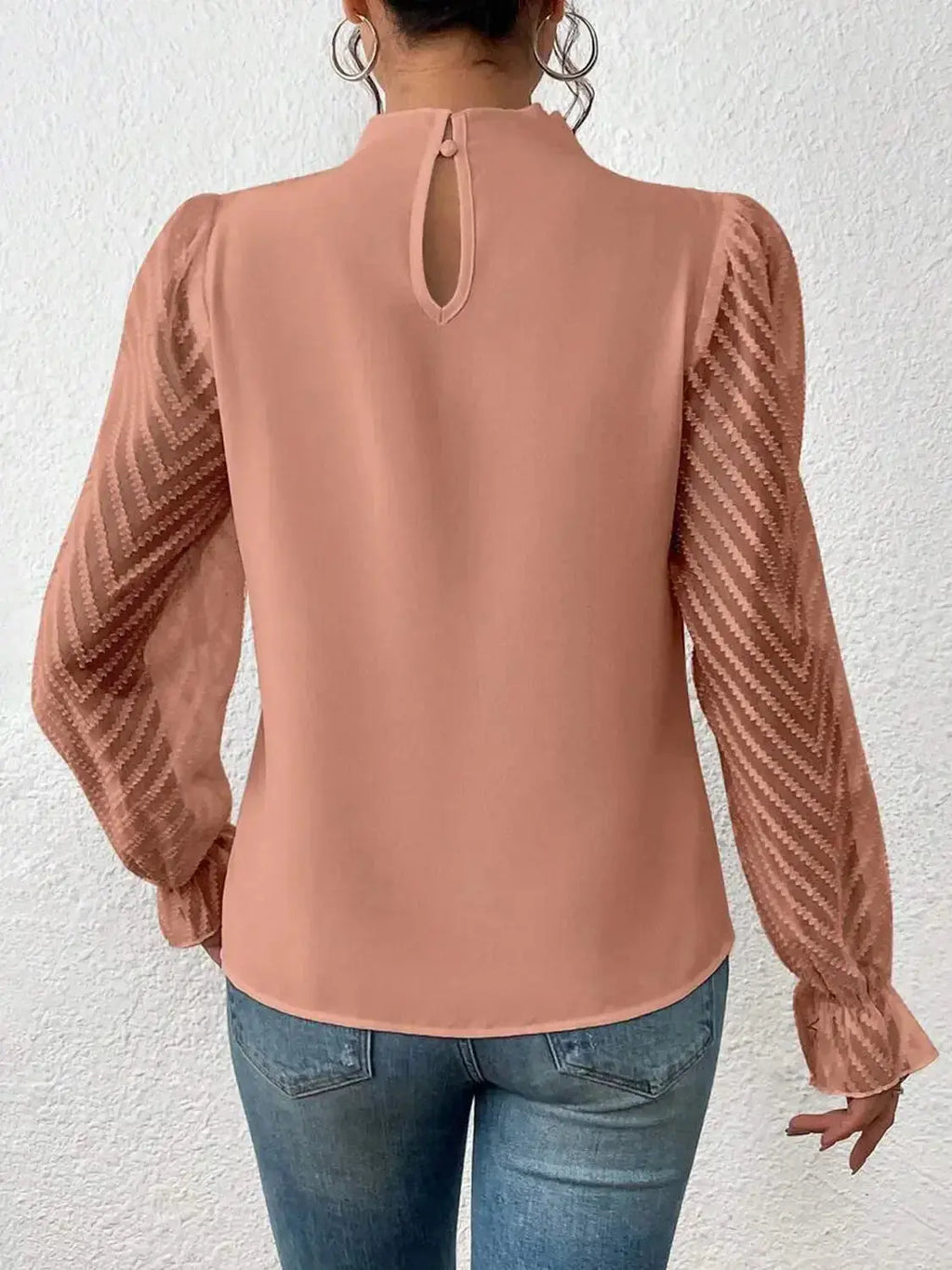 Elegant plush fabric mock neck blouse with flounce sleeves from Plush Fashion Hub, shown on a model.