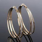 Modern multilayer forked circle earrings in two-tone gold and silver, featuring layered design and geometric shape.