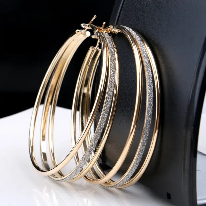 Modern multilayer forked circle earrings in two-tone gold and silver from Plush Fashion Hub, featuring layered geometric design.