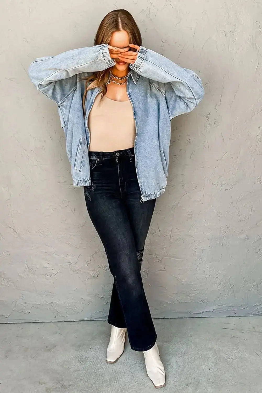 Myosotis zip-up denim jacket by Gilded Glamour Shop featuring raglan sleeves and an elastic hem, displayed on a hanger.