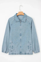 Blue denim jacket with zip-up front, raglan sleeves, and elastic hem by Gilded Glamour Shop, styled as a casual women's jacket.