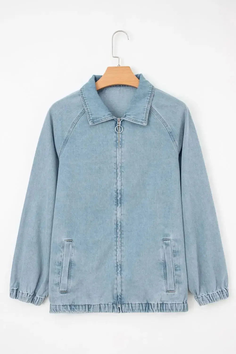 Blue denim jacket with zip-up front, raglan sleeves, and elastic hem by Gilded Glamour Shop, styled as a casual women's jacket.