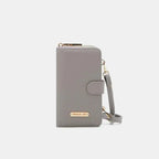 Convertible vegan leather crossbody phone case and wallet by Plush Fashion Hub, with multiple compartments and a sleek design.