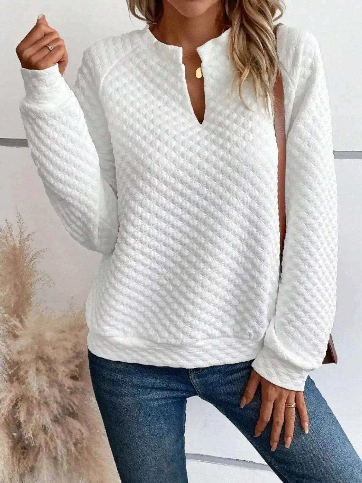 Women's plush fashion hub waffle-knit sweatshirt with notched raglan sleeves and soft textured pullover design.