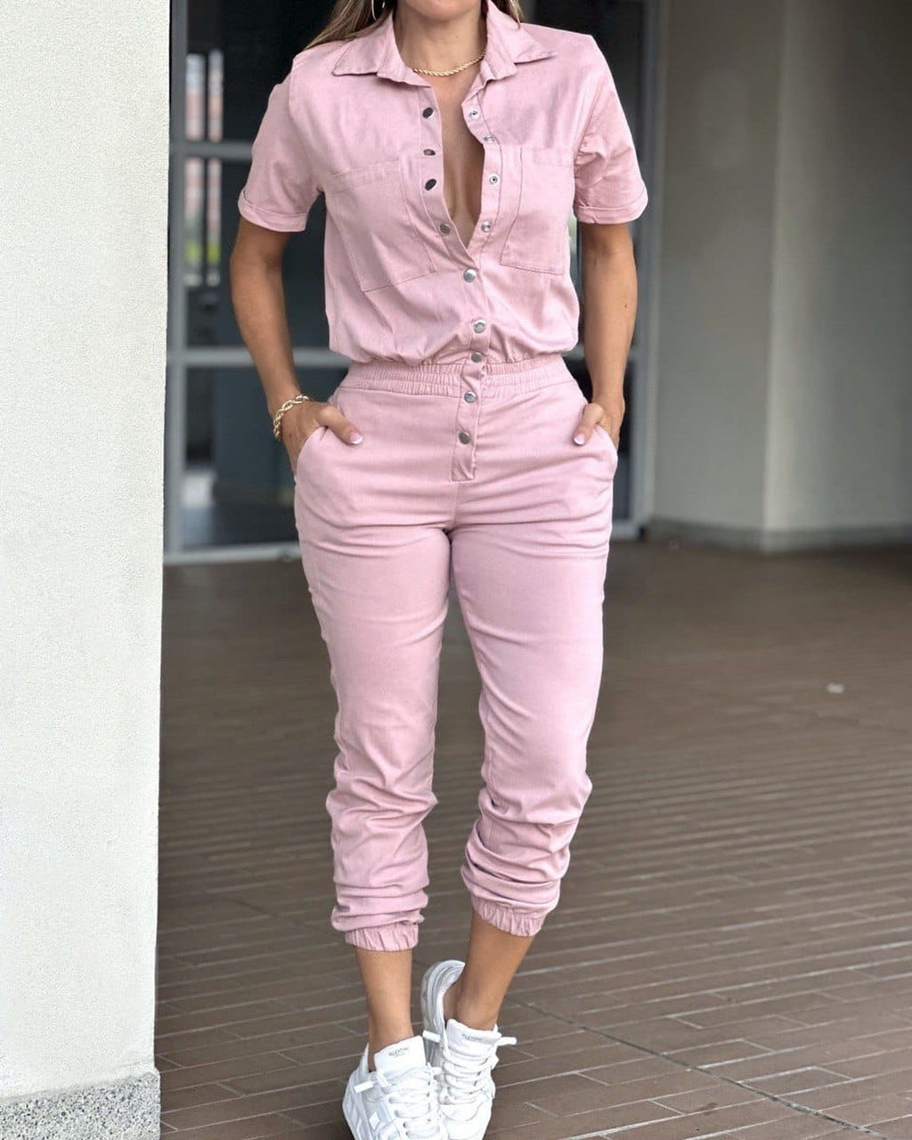 Casual women's ankle-tied jumpsuit with collar, pockets, elastic waist, and button details, by Wanita Store.
