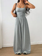 Casual women's summer jumpsuit with wide-leg design, wrapped chest, nipped waist, and suspenders, by Plush Fashion Hub.