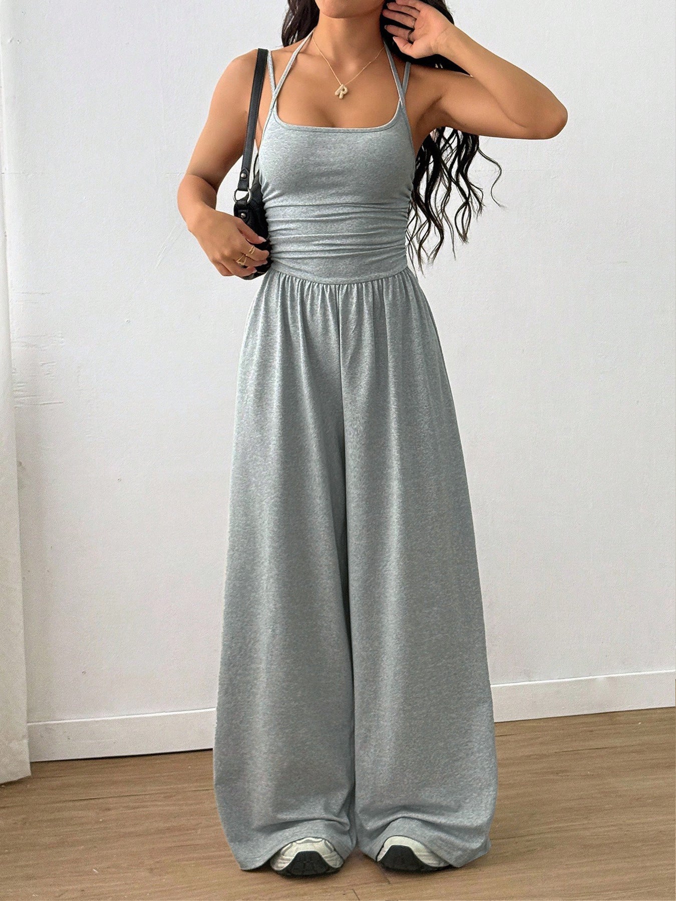 Casual women's summer jumpsuit with wide-leg design, wrapped chest, nipped waist, and suspenders, by Plush Fashion Hub.