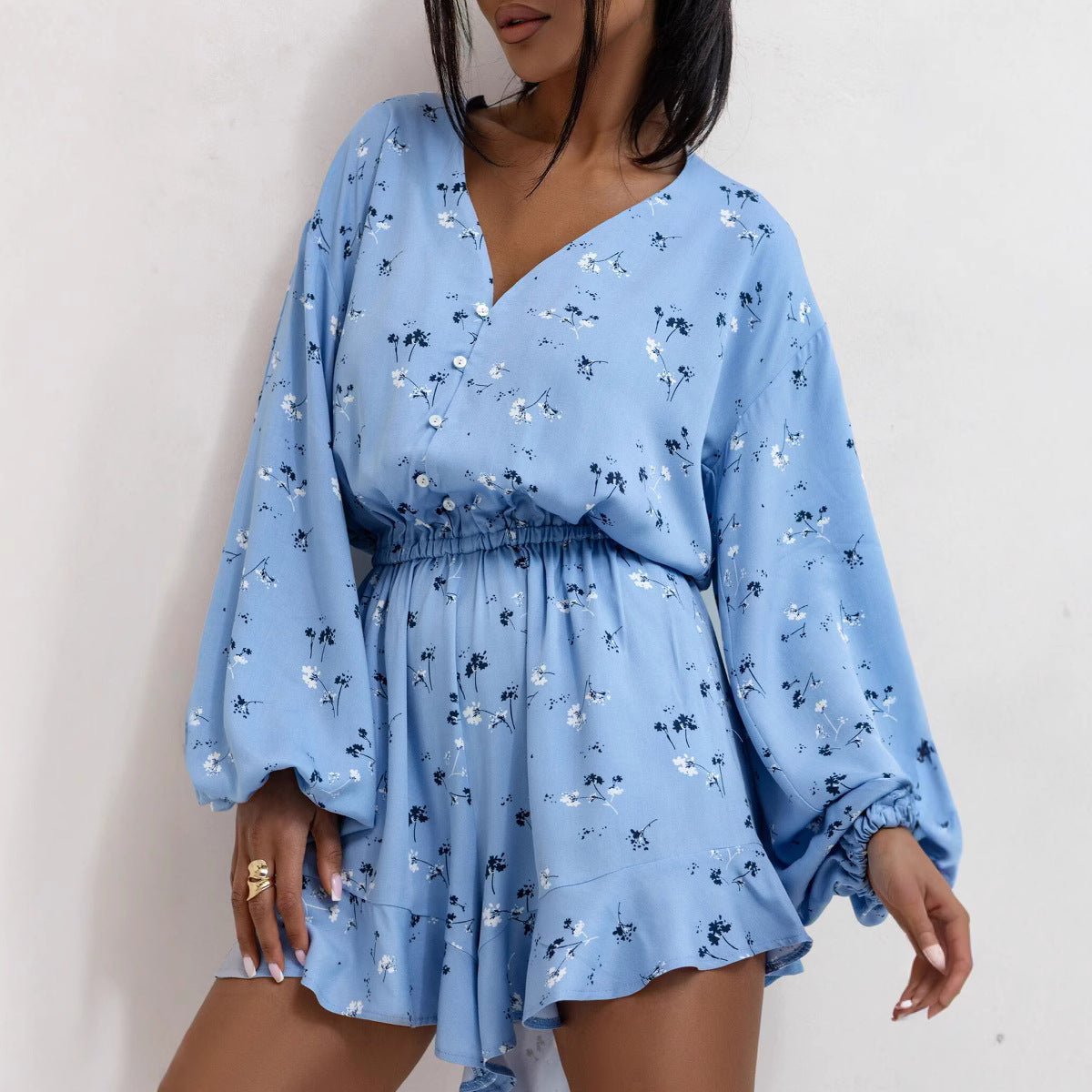 Women's summer jumpsuit by Bella Mia featuring a V-neck, printed long sleeves, waist trimming, ruffles, and shorts design.