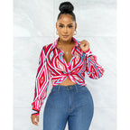 Women’s Bella Mia twist button shirt top with geometric pattern print, featuring a stylish collar and long sleeves.