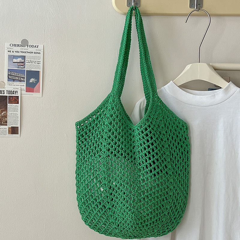 Large cotton woven straw bag with cutout design, ideal for casual beach or vacation use, featuring an idle shoulder style.