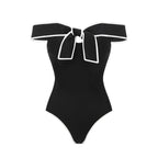 Black and white swimsuit with a bow and matching white skirt for women, featuring a sweet girl-inspired design by Plush Fashion Hub.
