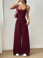 Women’s casual summer jumpsuit with wide legs, wrapped chest, nipped waist, and suspenders by Plush Fashion Hub.