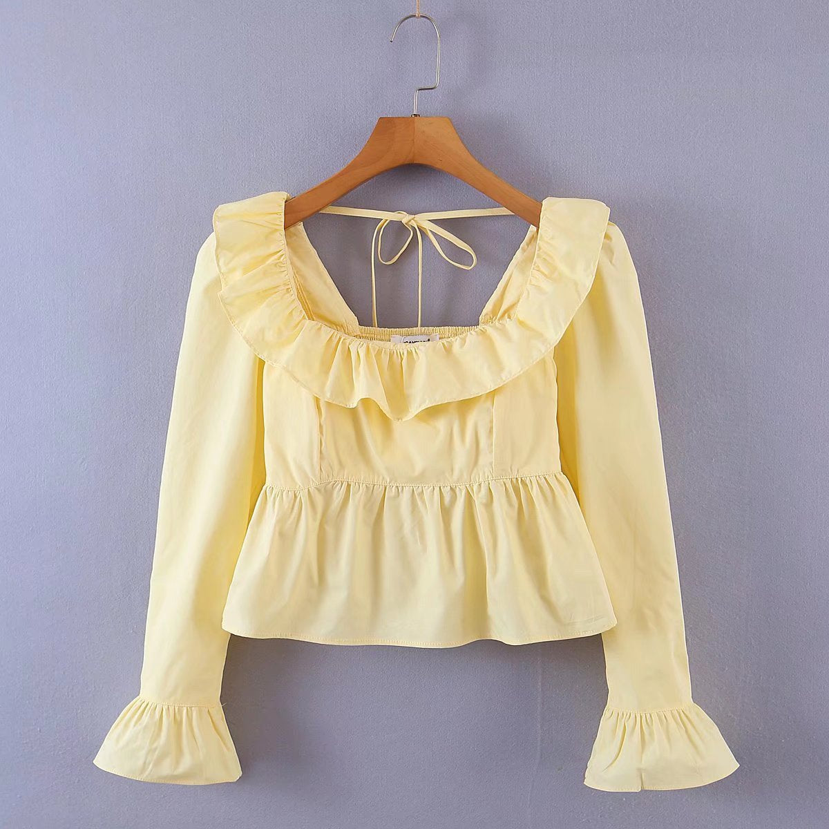 Summer Wind Bella Mia women's long sleeve ruffled shirt in solid color, featuring a stylish design and lightweight fabric.