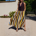 Elegant women's striped printed skirt with slit hemline, featuring a stylish design and flowy fabric.