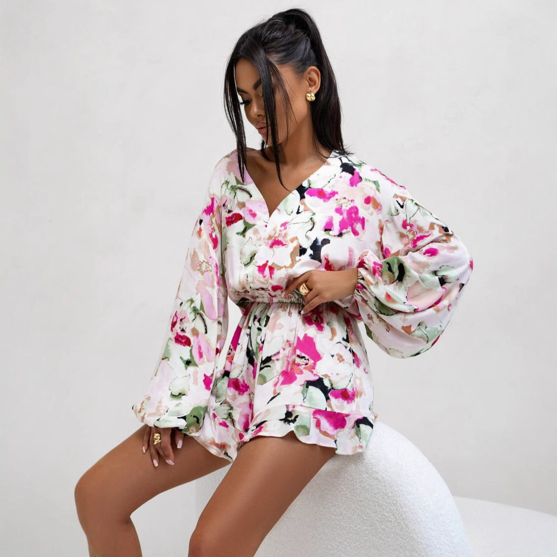 Bella Mia women's summer jumpsuit with V-neck, printed long sleeves, ruffles, waist trimming, and shorts, perfect for warm weather.